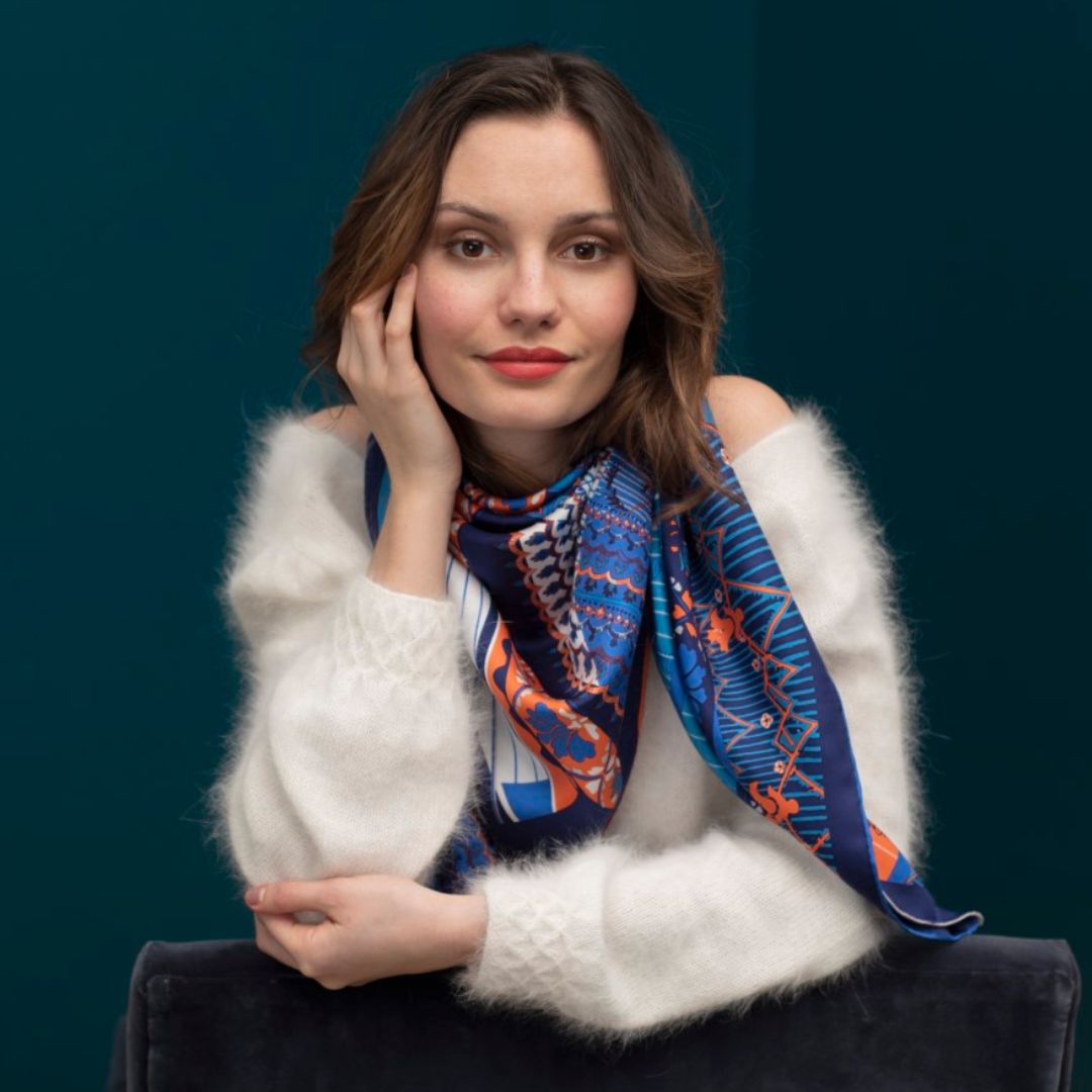 Woman from front leaning on her elbow with Petrusse Paris Navy silk scarf