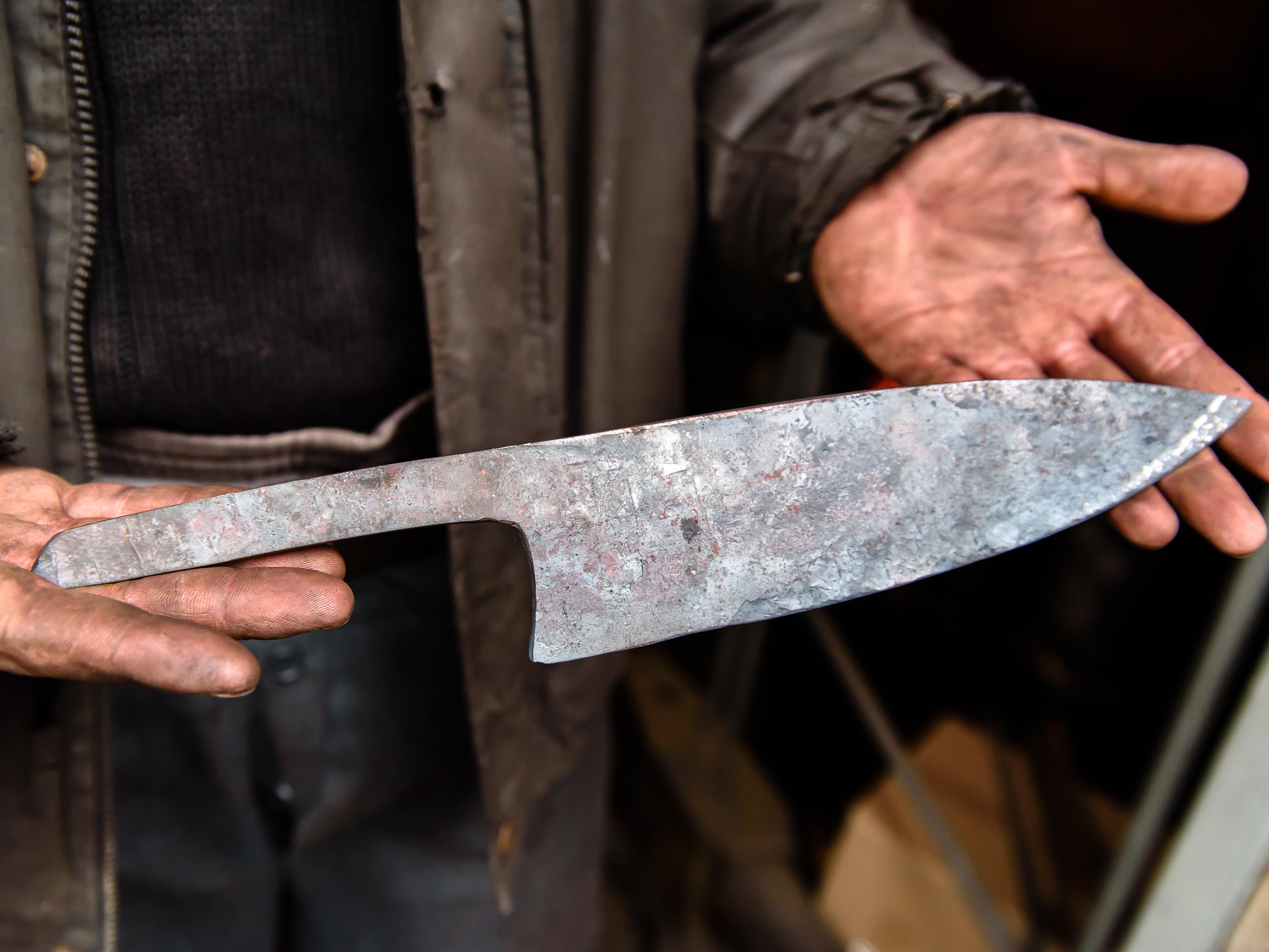 Forged knife in hand of a worker
