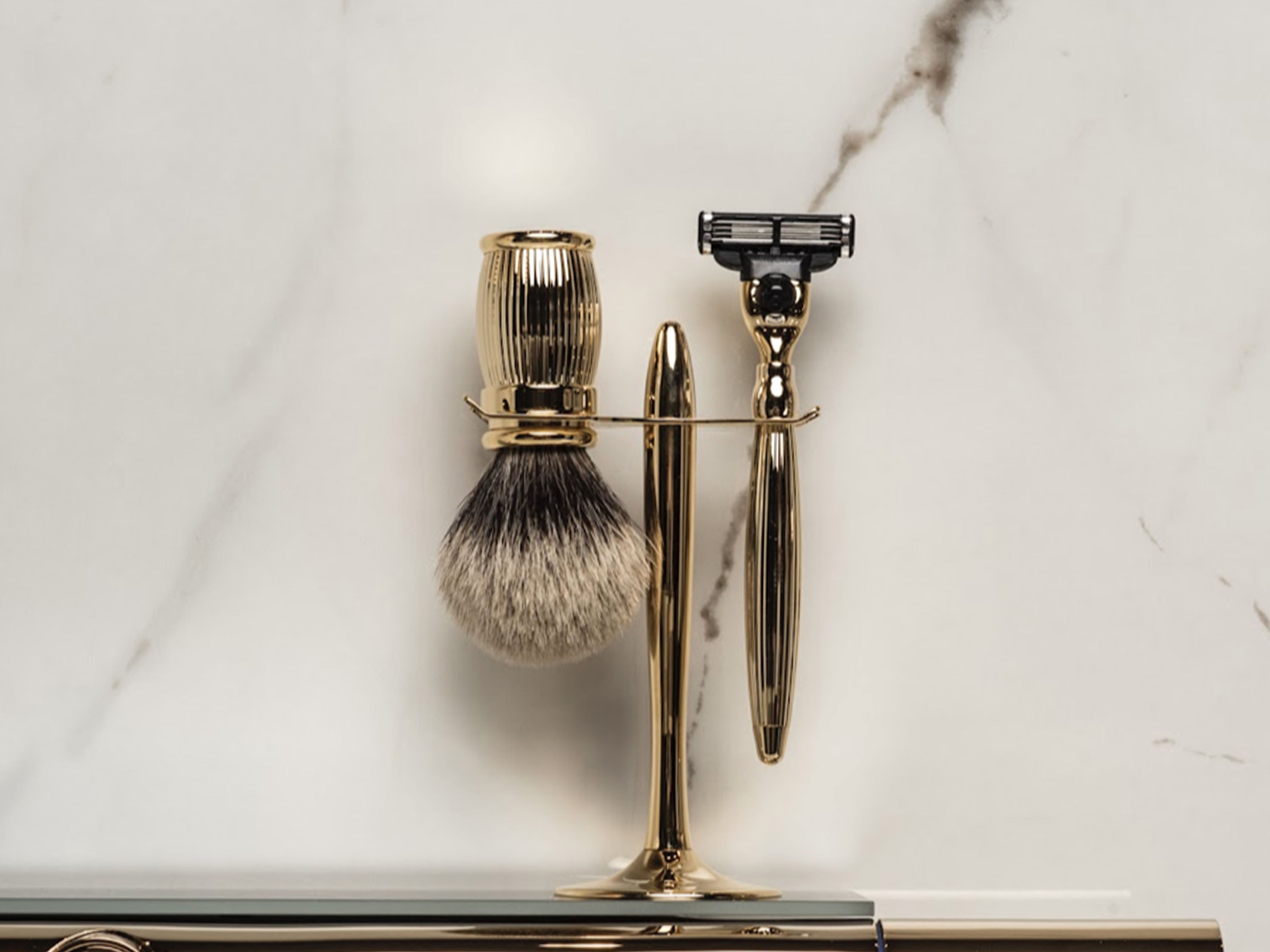 Razor and Brush on a stand with marble background