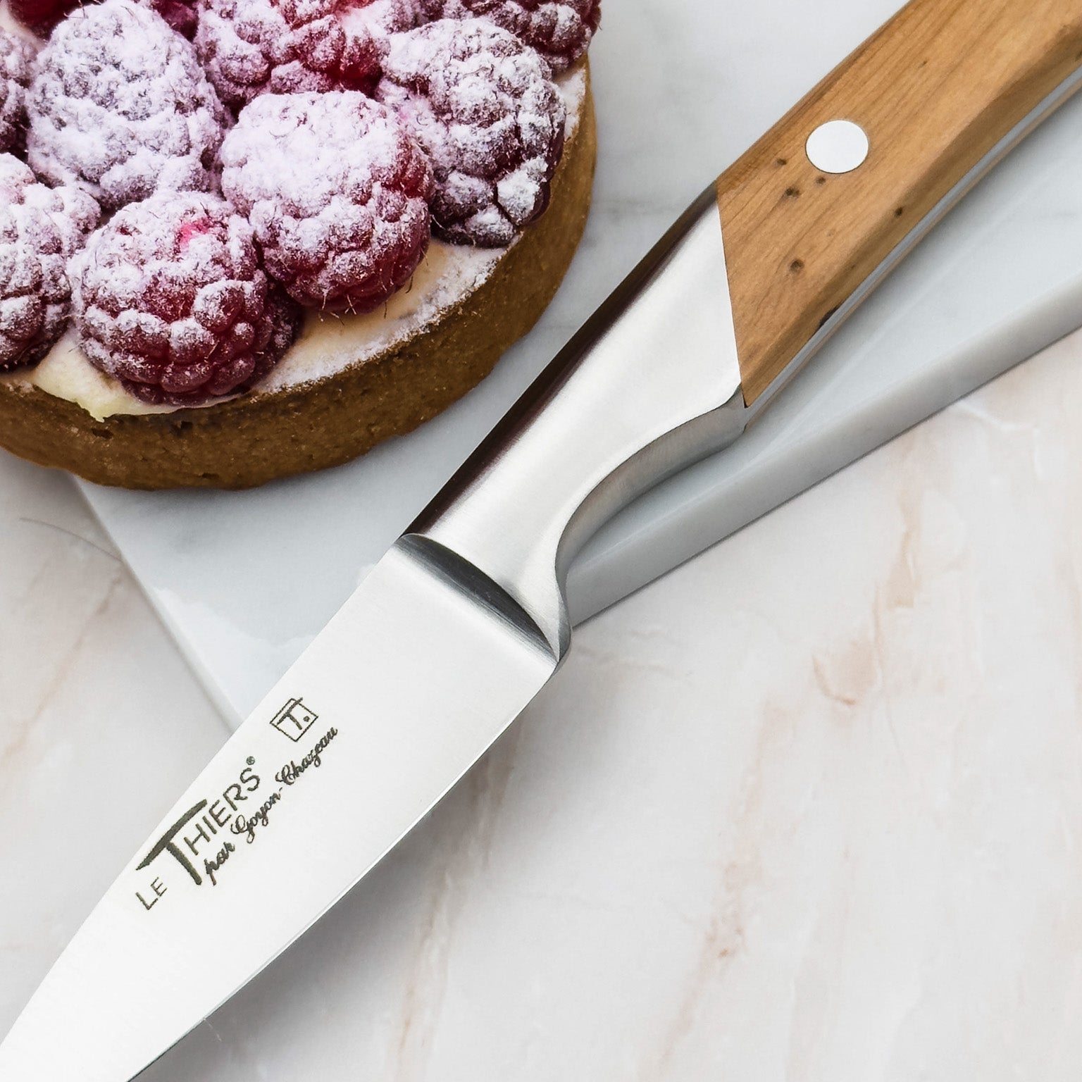 French knife with pastry on marble