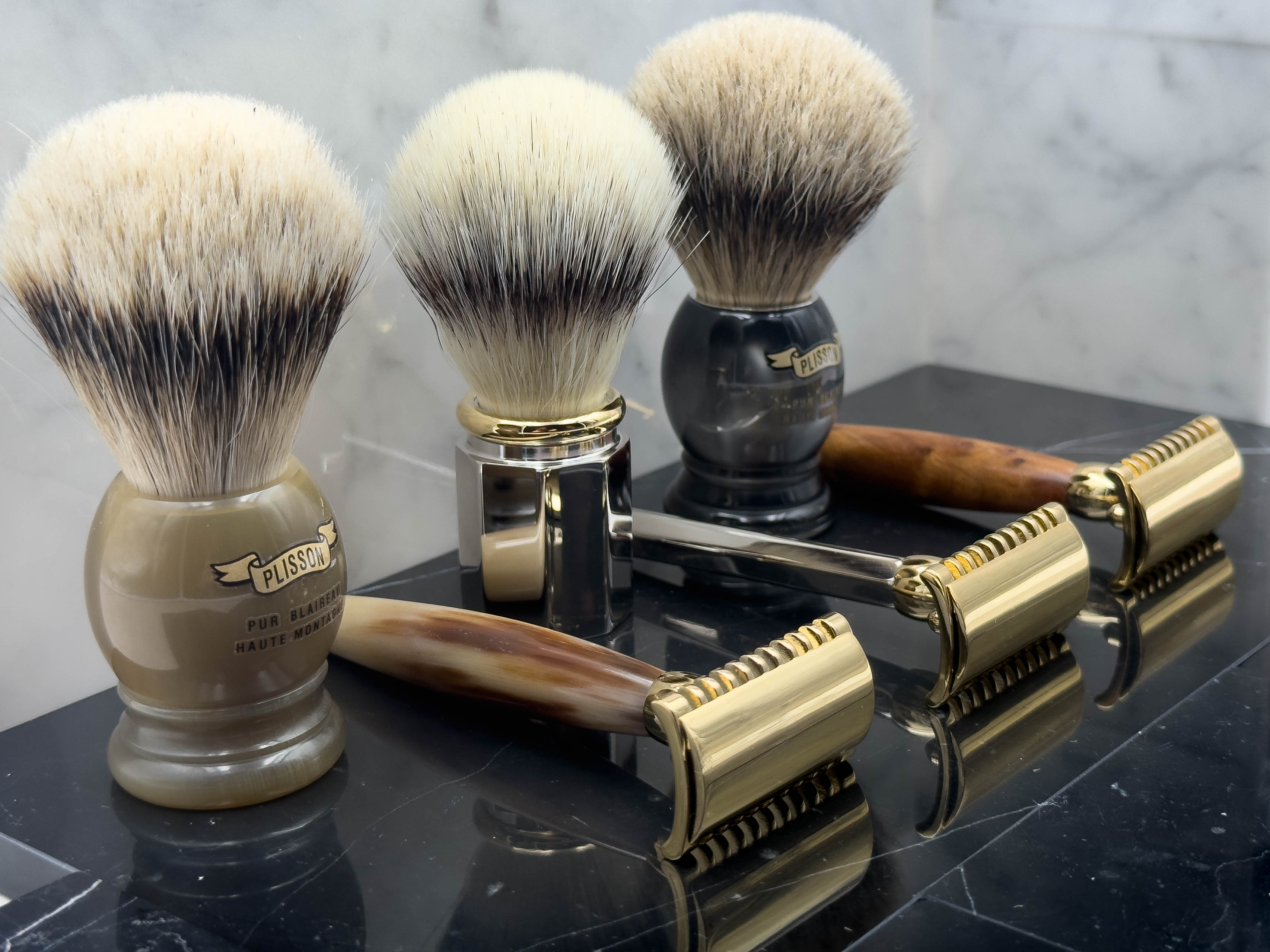 Plisson badgers and razors on marble